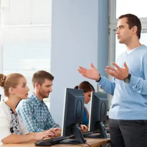 Teen team participating in a fundraising ideas workshop at a computer lab.