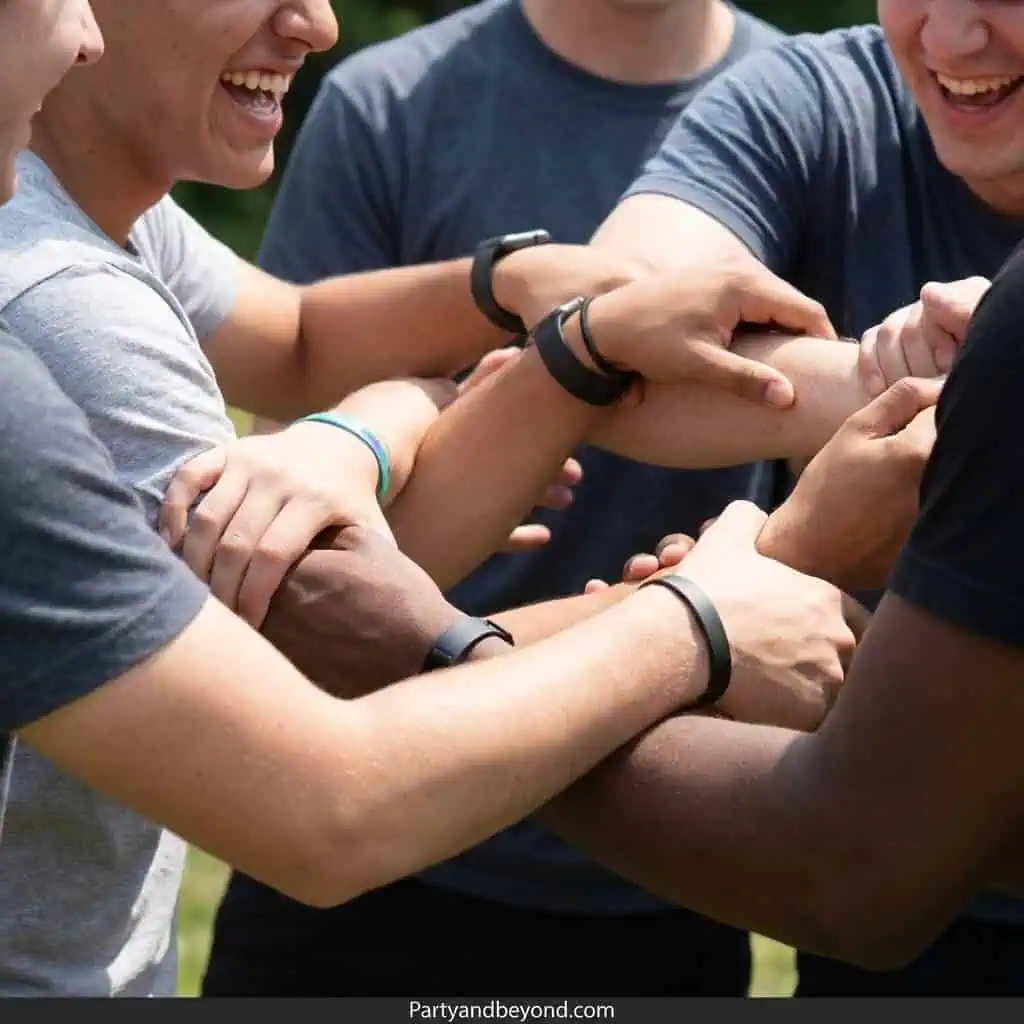 Group of teenagers playing a fun team game outdoors.