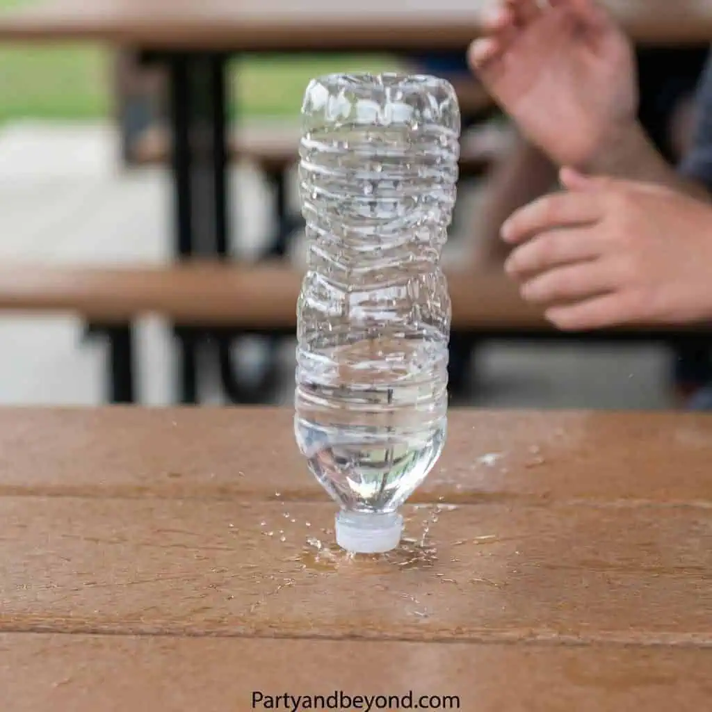 Creative water bottle challenge at a party with friends.