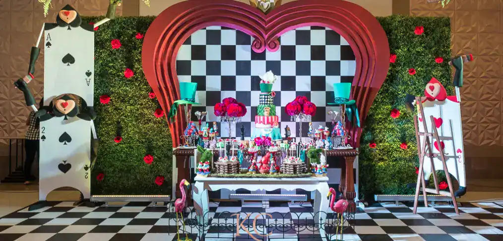 Colorful Alice in Wonderland themed birthday party with vibrant decorations and themed table display.