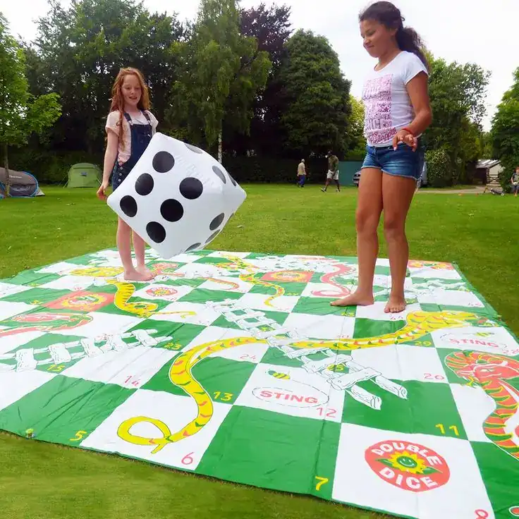 Students playing giant board games including oversized Jenga at an end-of-year school party