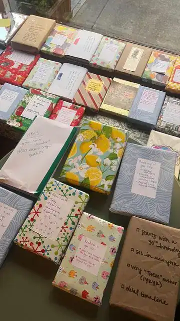 Wrapped books with recommendation tags at a student book swap end-of-year school party