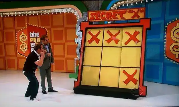 Students competing in a game show challenge at an end-of-year school party with teams and scoreboard