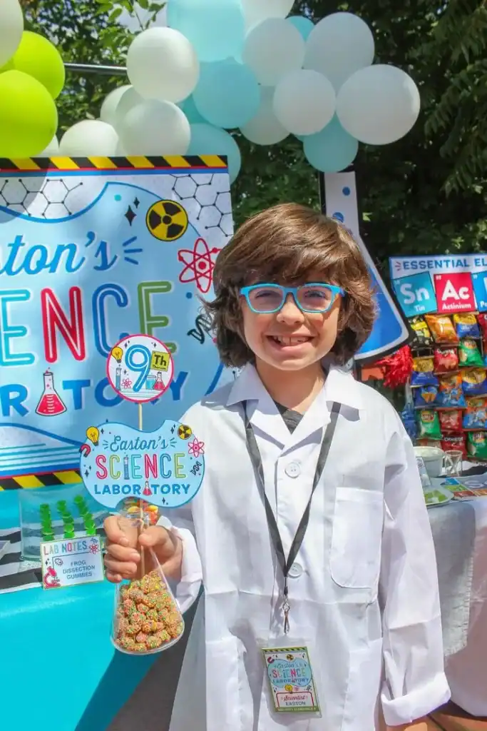 Students doing science experiments with colorful reactions at a science-themed end-of-year school party