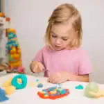 25 Easy New Year Crafts for Kids Young girl creating colorful New Year craft decorations for kids' celebration.