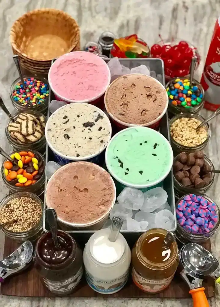 Ice cream sundae bar with toppings stations set up for an end-of-year school party celebration