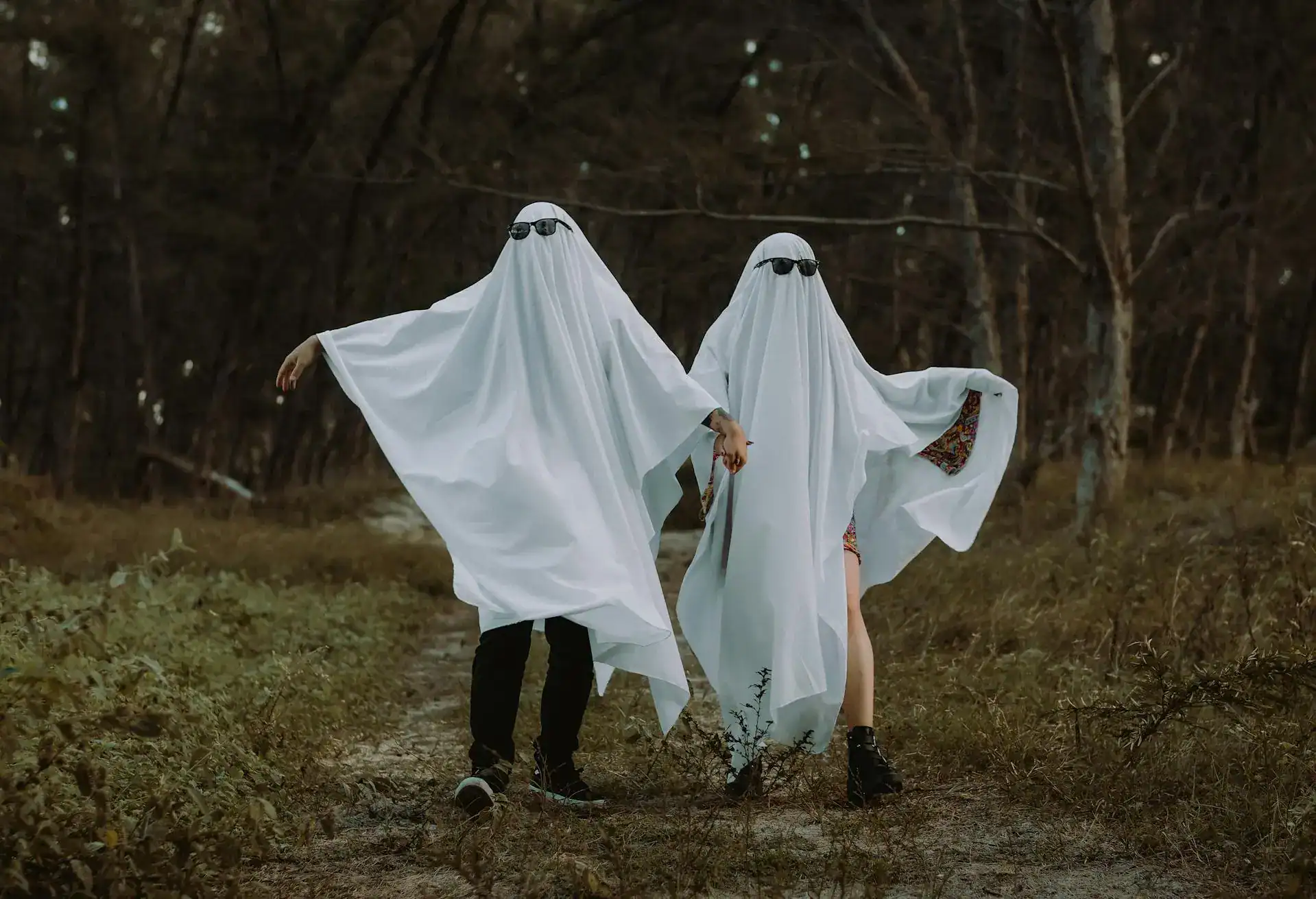 Ghost costumes with sunglasses for humorous New Year outfits.