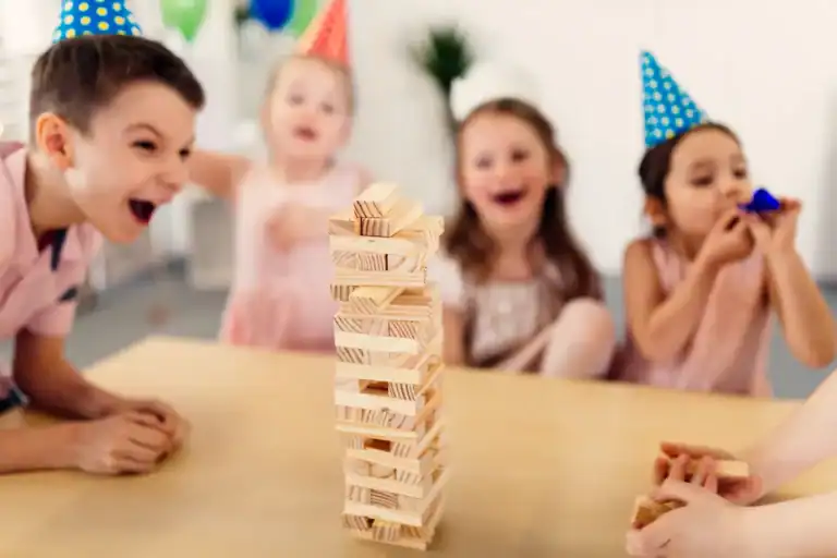 Children playing Jenga game at a New Year’s Eve party.