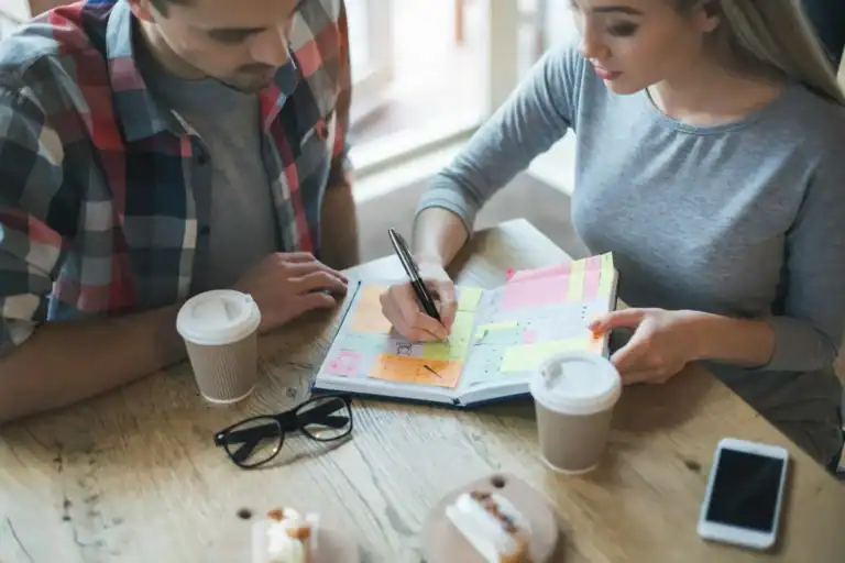 Couple planning New Year bucket list ideas together.