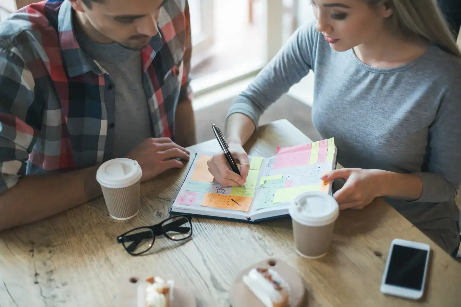 Couple planning New Year bucket list ideas together.