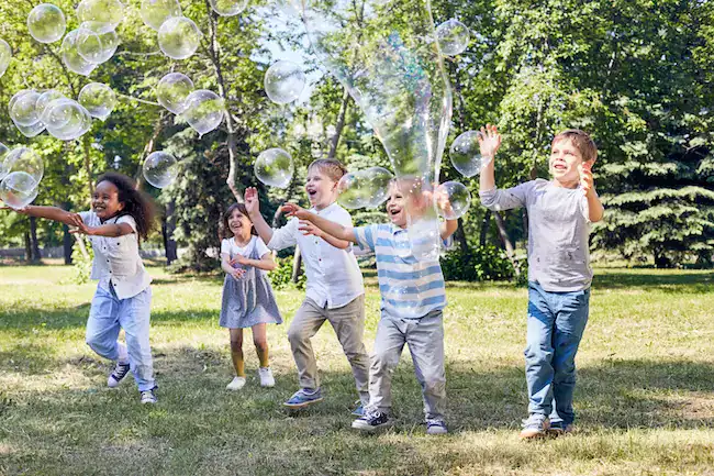 Kids playing with bubbles at a birthday party