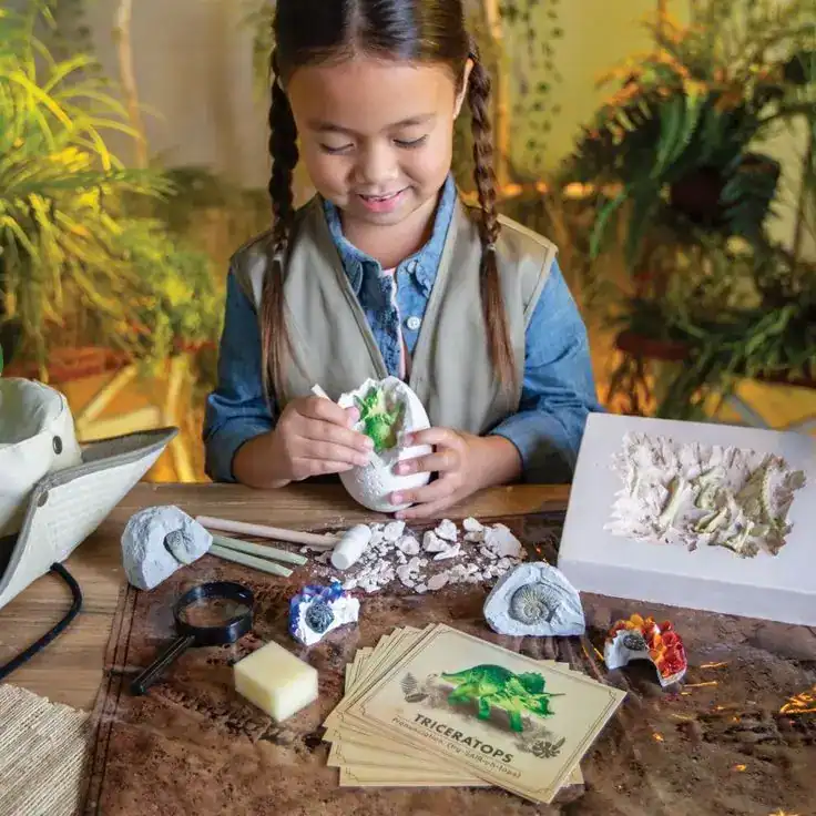 Kids engaging in creative dinosaur fossil activity.
