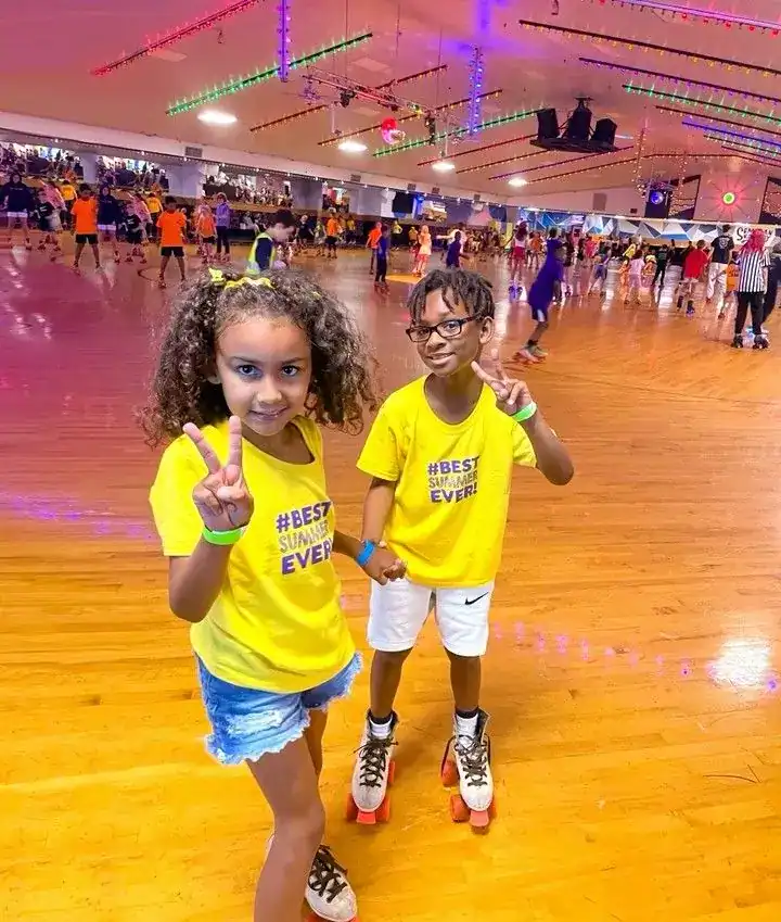 Kids roller skating fun at a vibrant indoor rink.