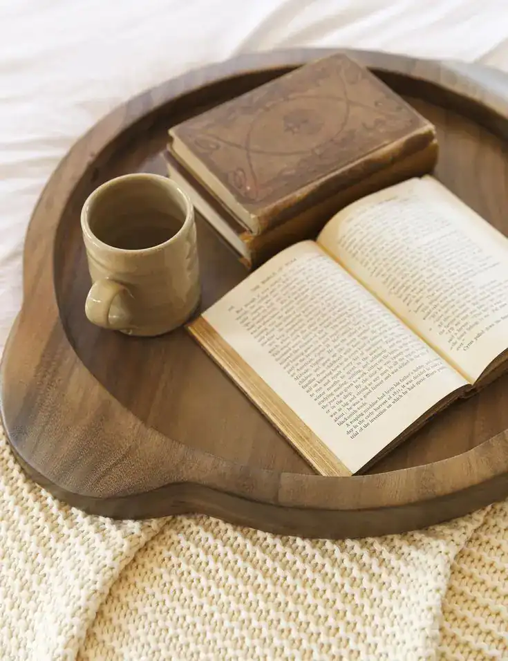 A warm, inviting scene featuring open books and a mug on a wooden tray, perfect for relaxing during.