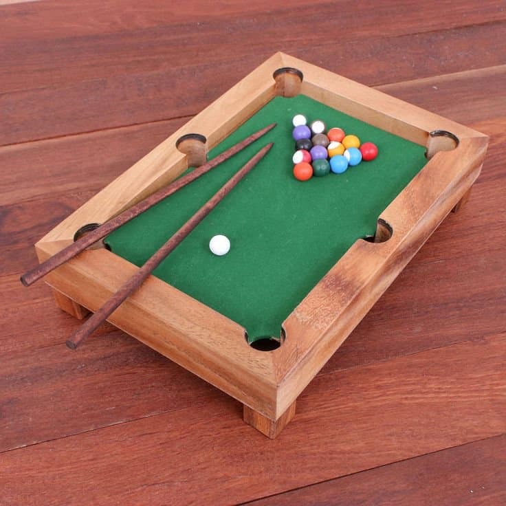 Mini pool table with billiard balls and cues, perfect for housewarming party favors.