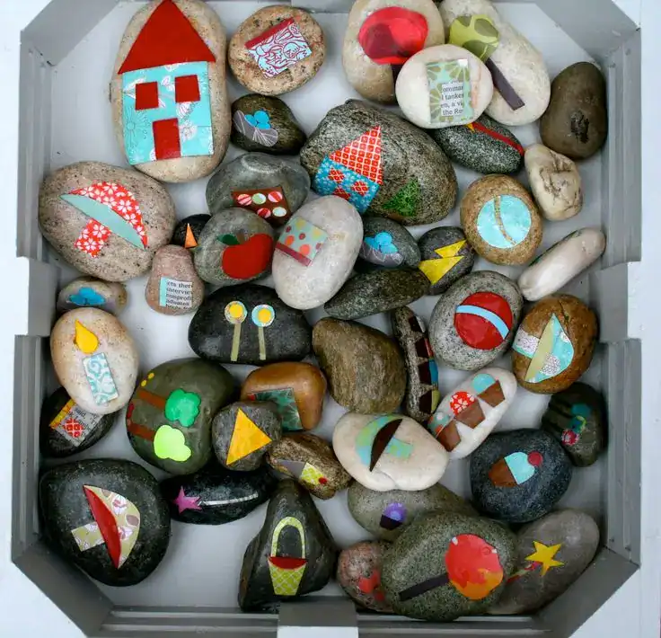 Colorful painted rocks with creative designs for children's art projects and gifts.