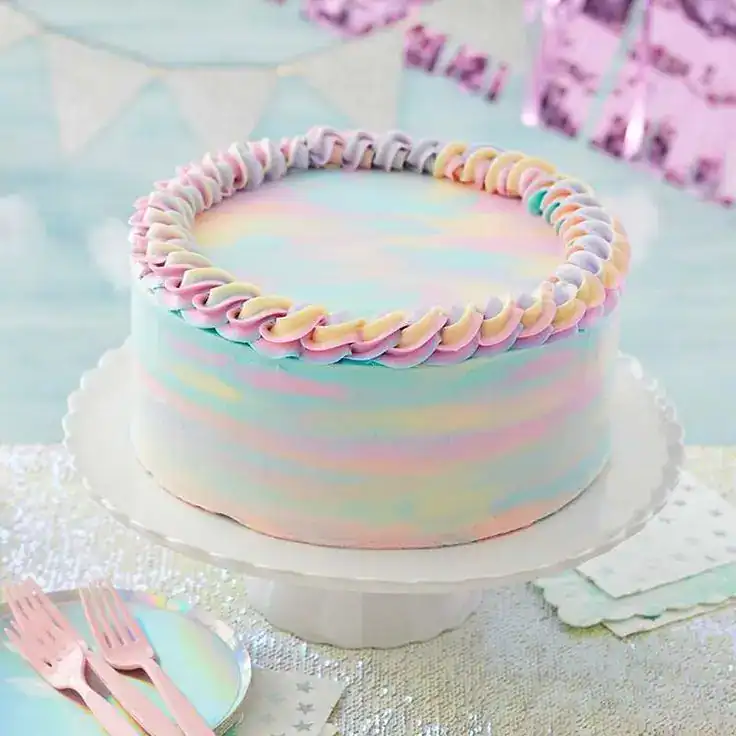 Watercolor birthday cake with blended pastel buttercream in coral, lavender, and mint palette knife strokes