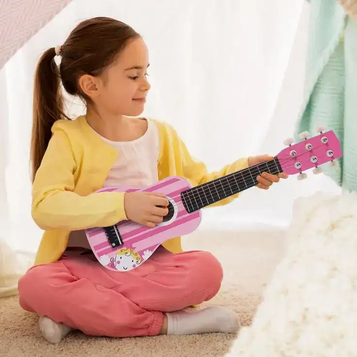 Young girl playing pink guitar, perfect non-toy birthday gift for kids.