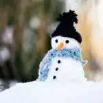 23 January Art Projects For Kids Snowman craft for kids with a black hat and blue scarf, perfect for winter art projects.