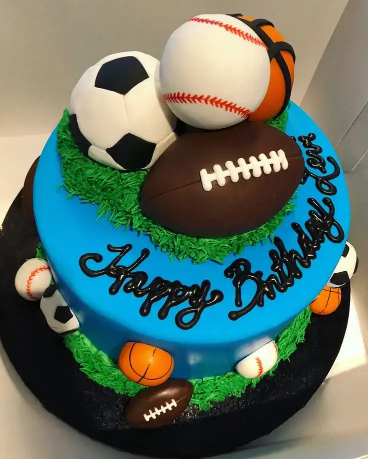 Sports birthday cake decorated with fondant football, soccer ball, and basketball toppers in team colors