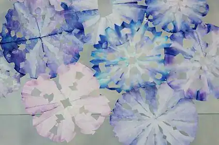 Colorful paper snowflakes for winter crafts, perfect for preschoolers.