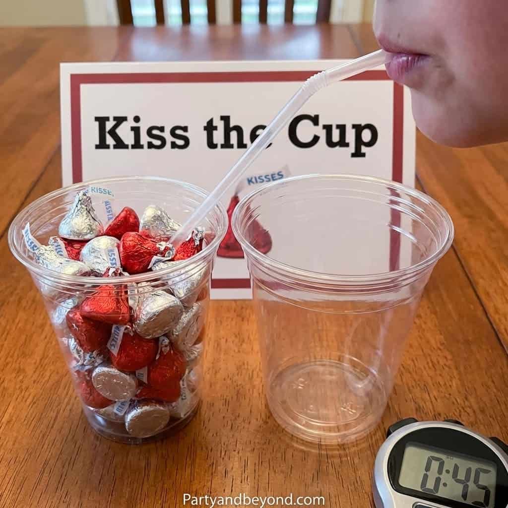 Fun Valentine's Day game with chocolates and cups for couples.