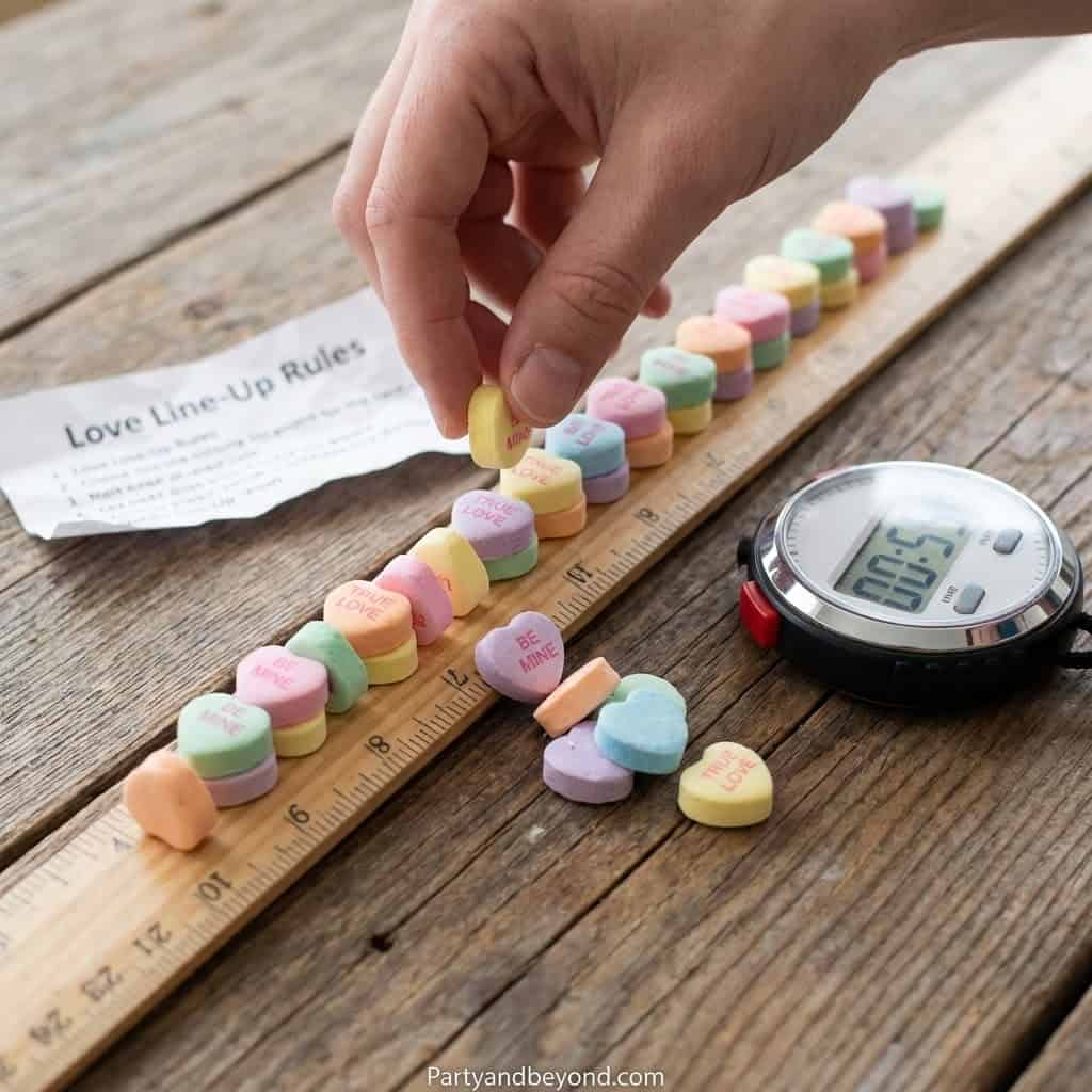 Valentine's Day-themed game with colorful heart-shaped candies and a timer on a wooden table.