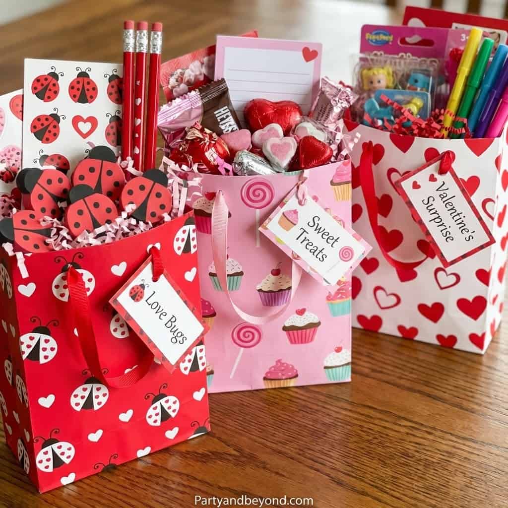 Valentine's Day classroom gift bags filled with candies, toys, and treats for kids. Perfect for scho.