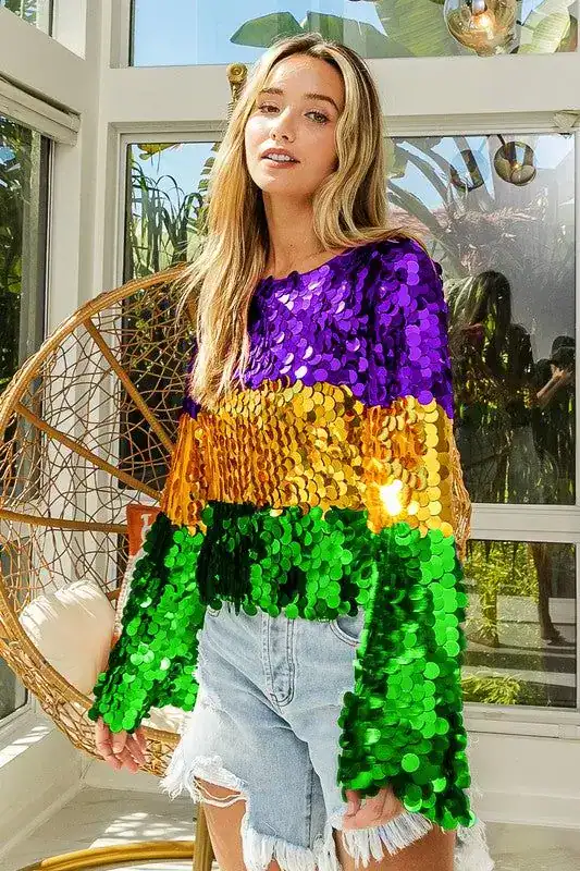 Bright sequin Mardi Gras outfit with purple, gold, and green colors.