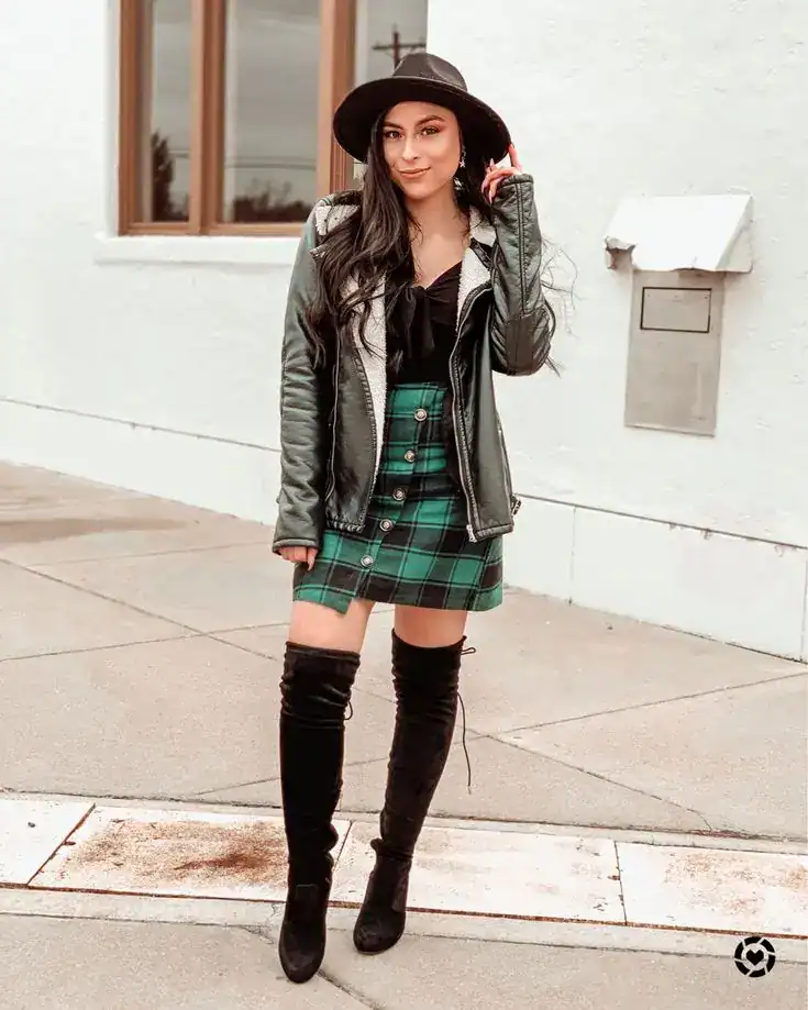 St. Patrick's Day outfit featuring a plaid skirt, leather jacket, and over-the-knee boots for women.