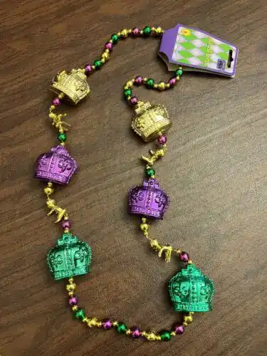 Colorful Mardi Gras bead necklace with mini crowns for festive celebration.