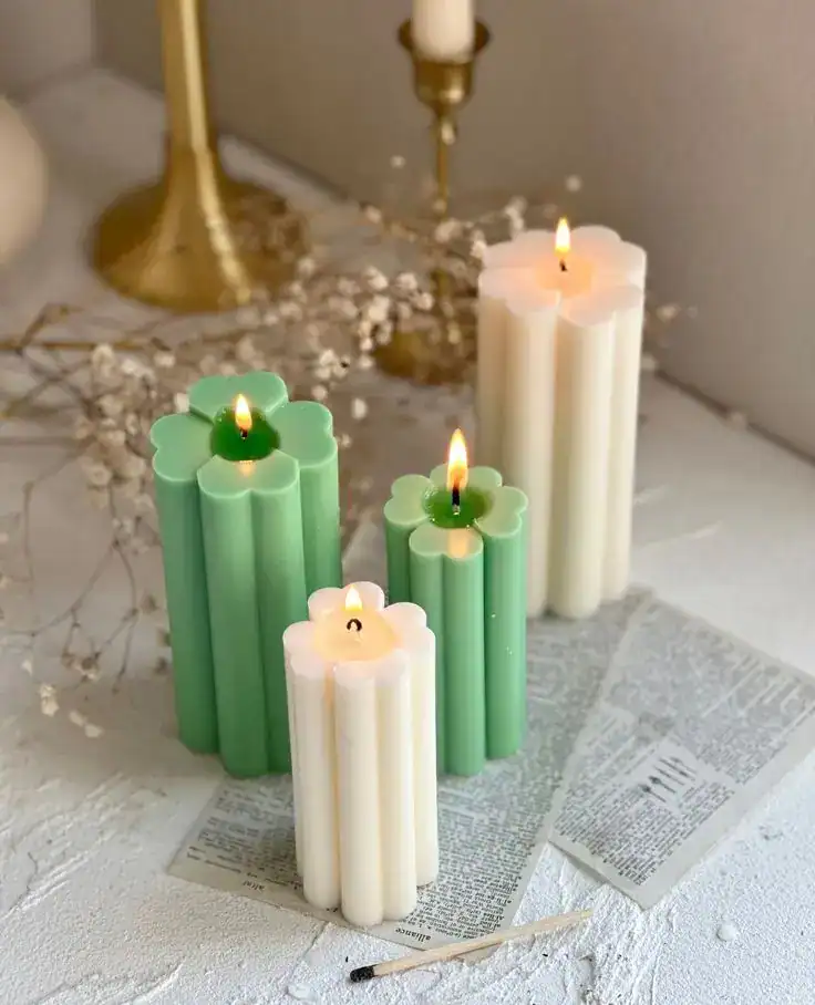 St. Patrick's Day candle centerpiece with green and white candles on a festive table.