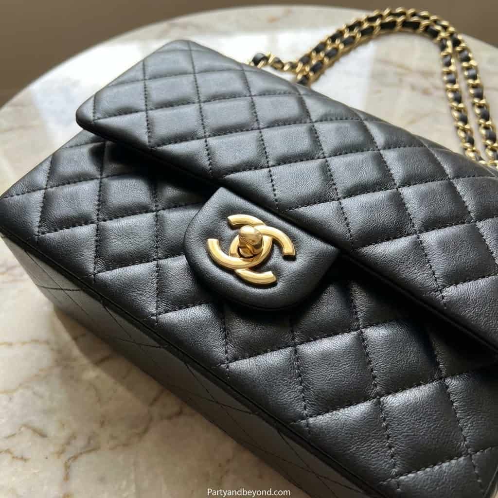 Luxury quilted black leather Chanel handbag with iconic gold chain strap and CC logo clasp.