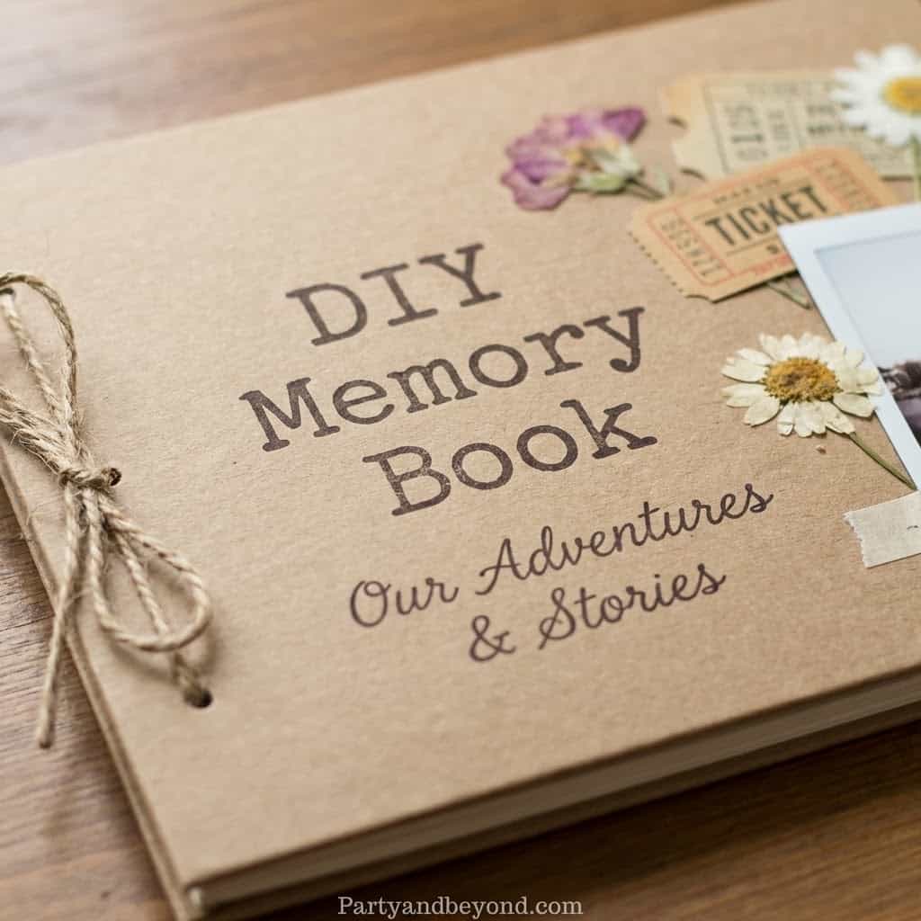 Personalized DIY memory book with floral decorations and travel-themed embellishments.