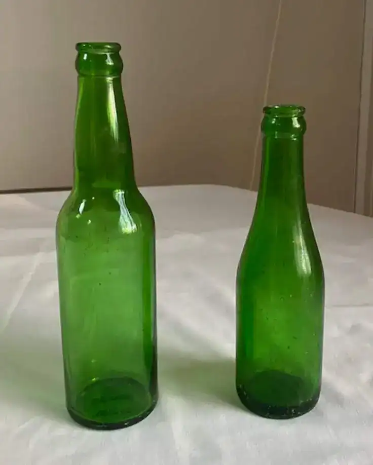 Green glass bottles for St. Patrick's Day decor, perfect for festive table settings and DIY decorations.