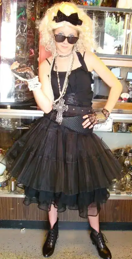 Mardi Gras costume with black dress, accessories, and sunglasses for a festive look.