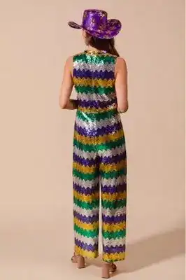 Woman in colorful Mardi Gras costume with hat, celebrating Mardi Gras.
