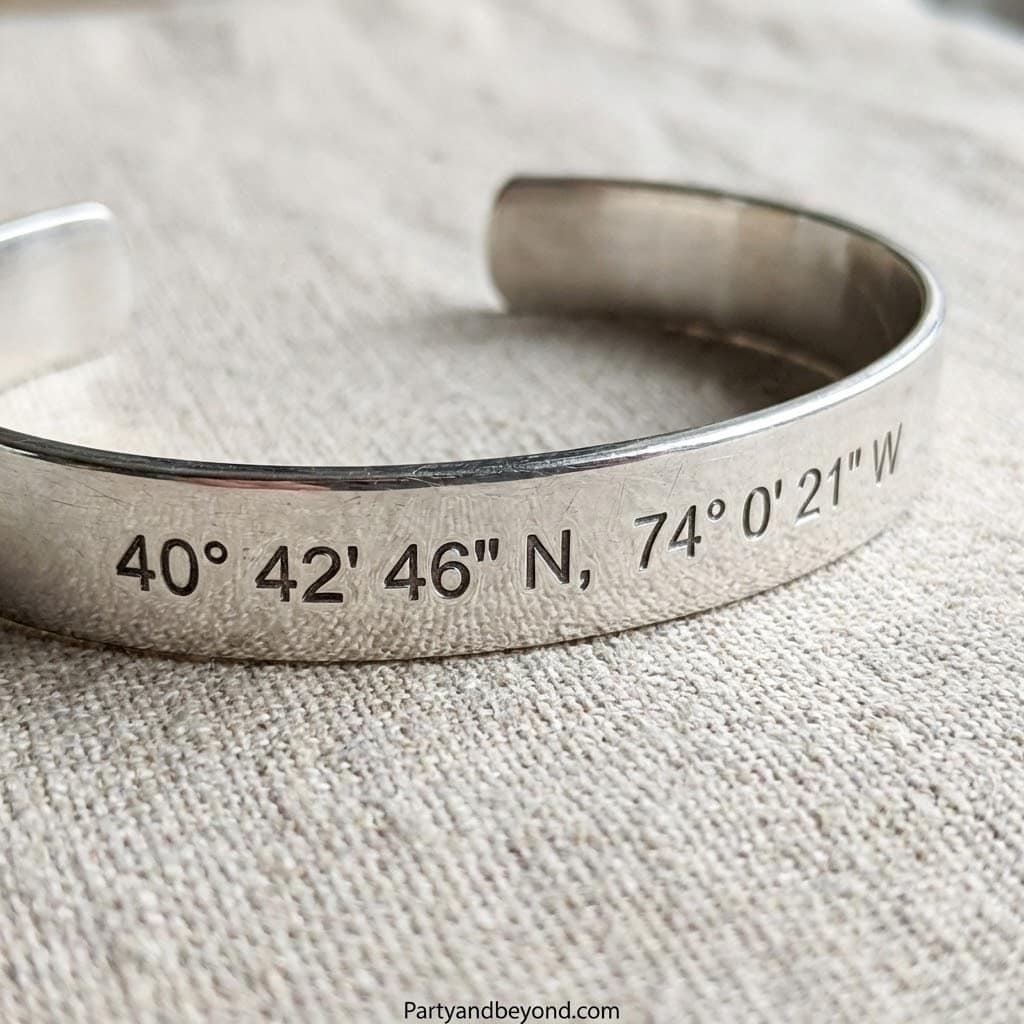 Elegant silver cuff bracelet engraved with specific GPS coordinates. Perfect unique anniversary gift.