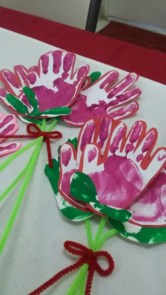 Colorful handprint flower craft for kids' spring activity.