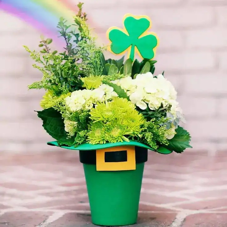 Festive St. Patrick's Day floral display with shamrock decoration.