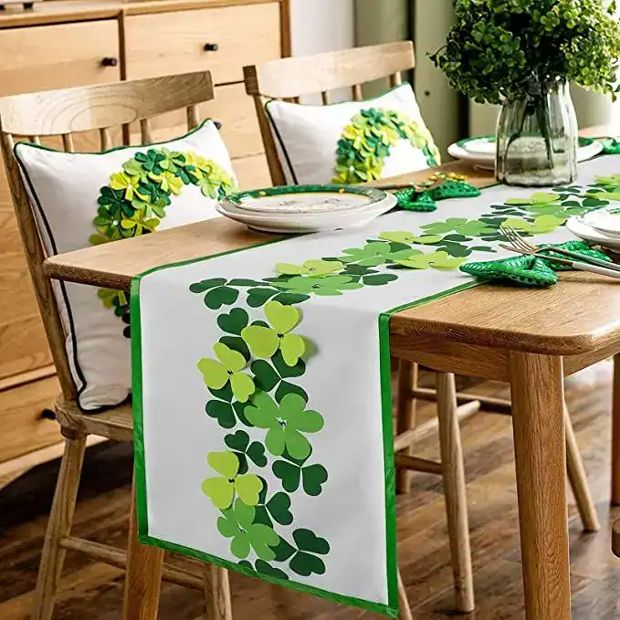 Festive St. Patrick's Day table setting with shamrock-themed table runner and cushions.