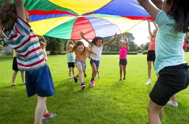 Colorful parachute play with children outdoors