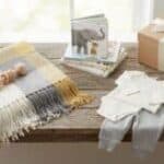 23 Useful Gender Reveal Gift Ideas for 2026: Unique and Gender-Neutral Gifts Elegant gender reveal gift setup with wrapped presents and neutral decor.