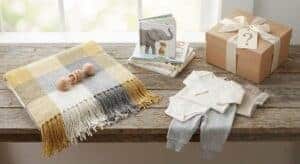Elegant gender reveal gift setup with wrapped presents and neutral decor.