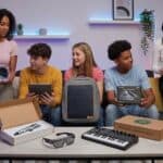 25 Unique Birthday Gift Ideas for Teens 2026 Teenagers exploring new tech gadgets at a birthday party.