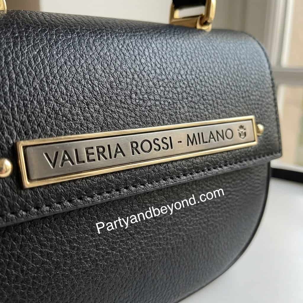 Close-up of Valeria Rossi Milano designer handbag with gold accents.