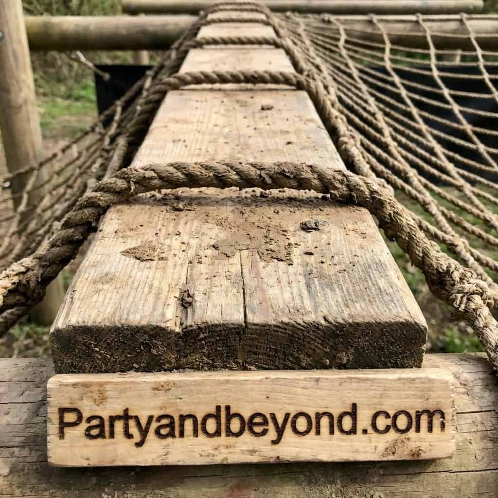Wooden bridge with ropes for kids' outdoor field day games at Party & Beyond!.