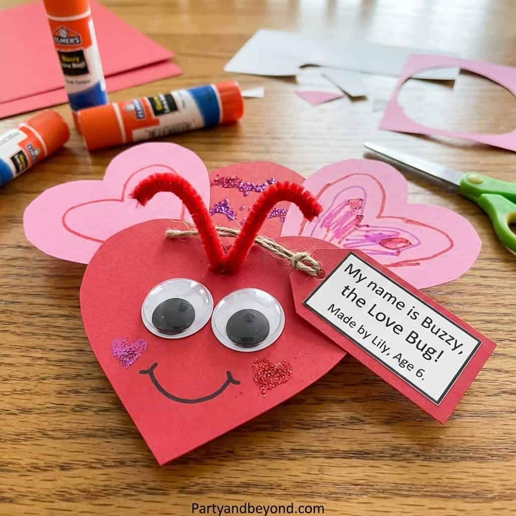 Valentine's Day craft featuring a cute paper heart bug with googly eyes and handmade wings, perfect.
