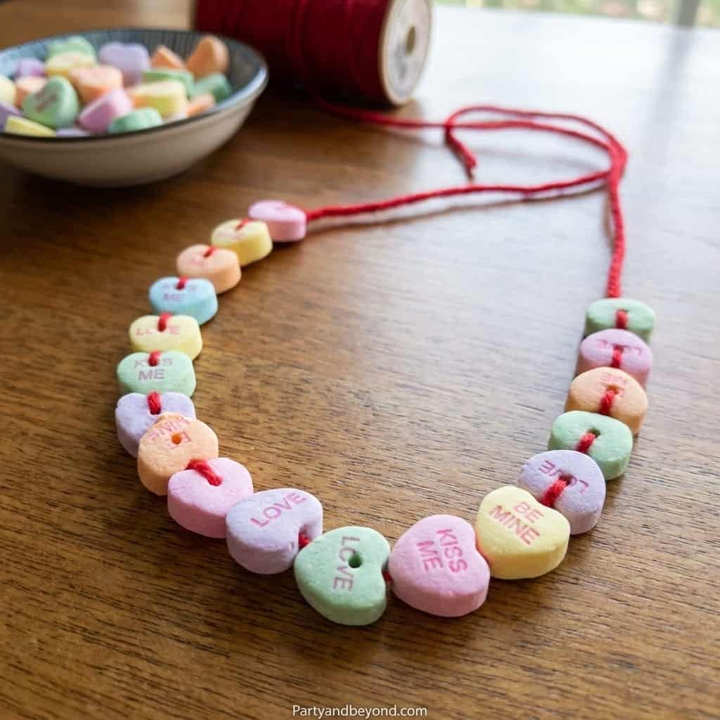 Colorful Valentine’s Day candy necklace with pastel heart-shaped candies on a string.
