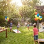 16 Backyard Birthday Party Ideas Outdoor backyard birthday celebration with kids playing and water games, colorful balloons, and fest.